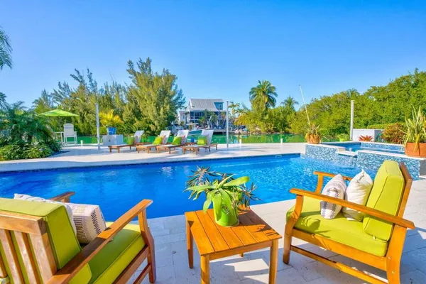 a view of a dining room with furniture and chandelier