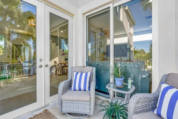 a view of a patio with table and chairs and potted plants