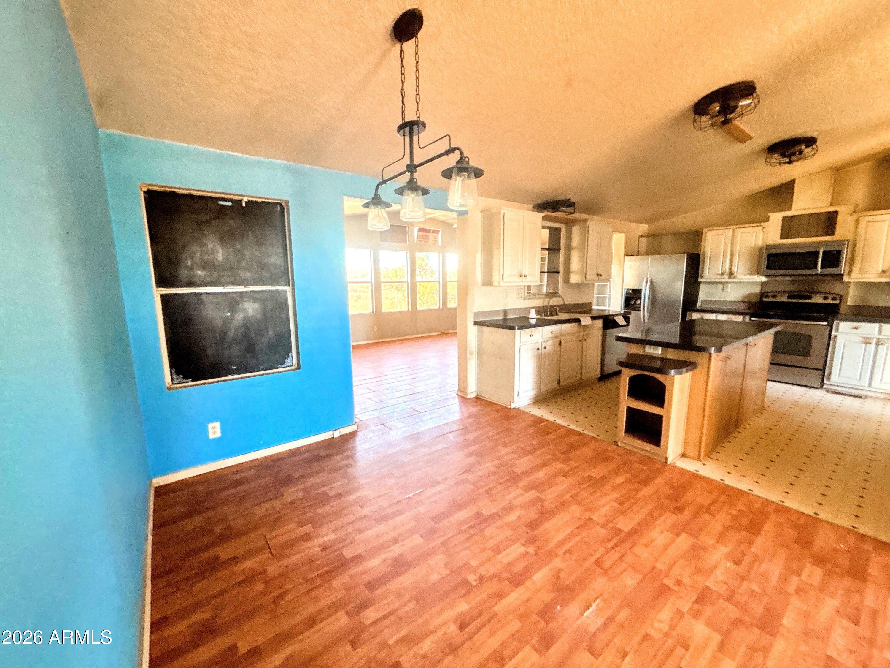 4038 Colt Road Snowflake, AZ 85937 - Photo 3 of 35 a living room with stainless steel appliances kitchen island granite countertop a sink and cabinets