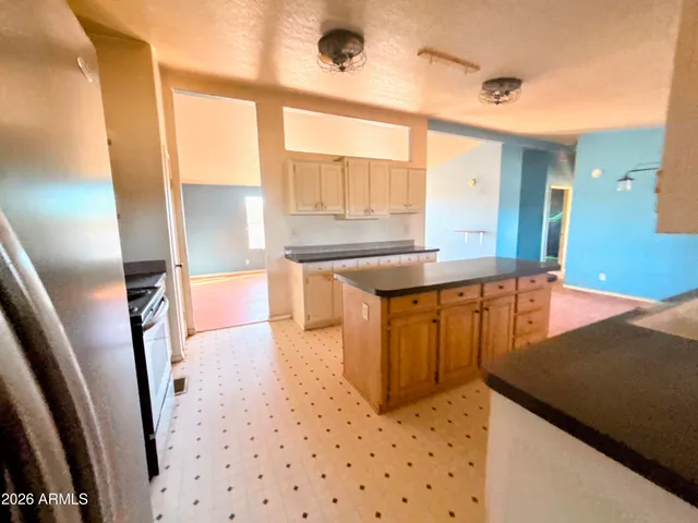 a bedroom with a bed and a flat tv screen on dresser