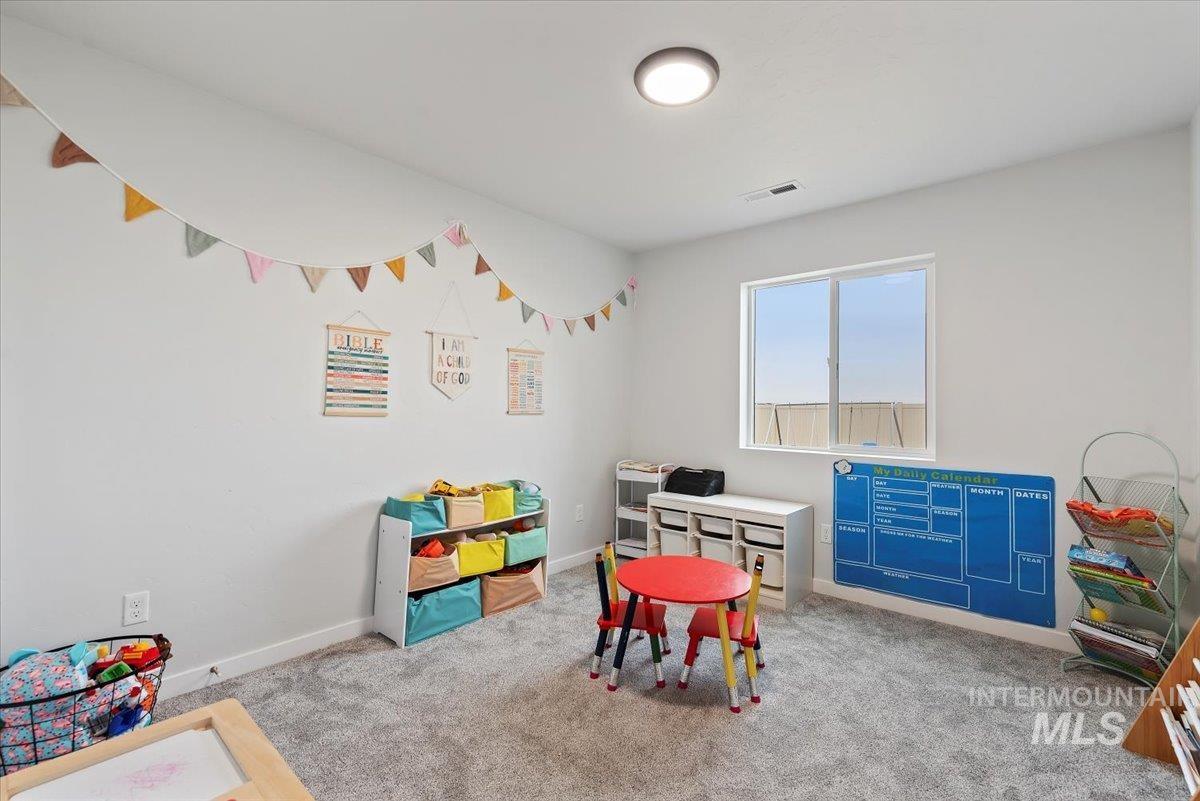 4086 North Kithnos Avenue Meridian, ID 83646 - Photo 16 of 29 Bedroom with baseboards and light colored carpet
