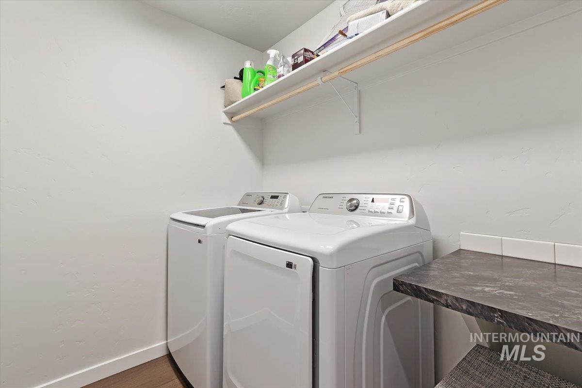 4086 North Kithnos Avenue Meridian, ID 83646 - Photo 25 of 29 Laundry room with independent washer and dryer and dark wood-type flooring