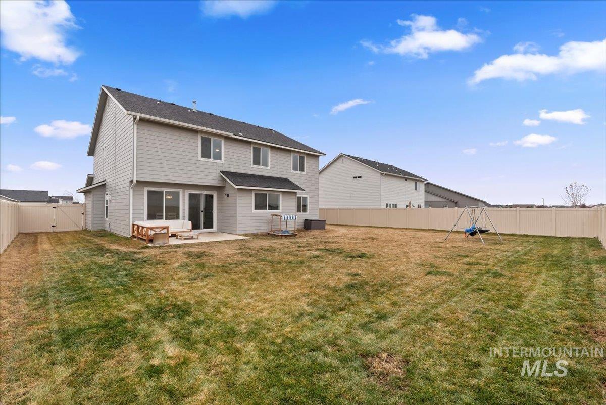 4086 North Kithnos Avenue Meridian, ID 83646 - Photo 27 of 29 Back of property with a fenced backyard, a gate, and a patio area
