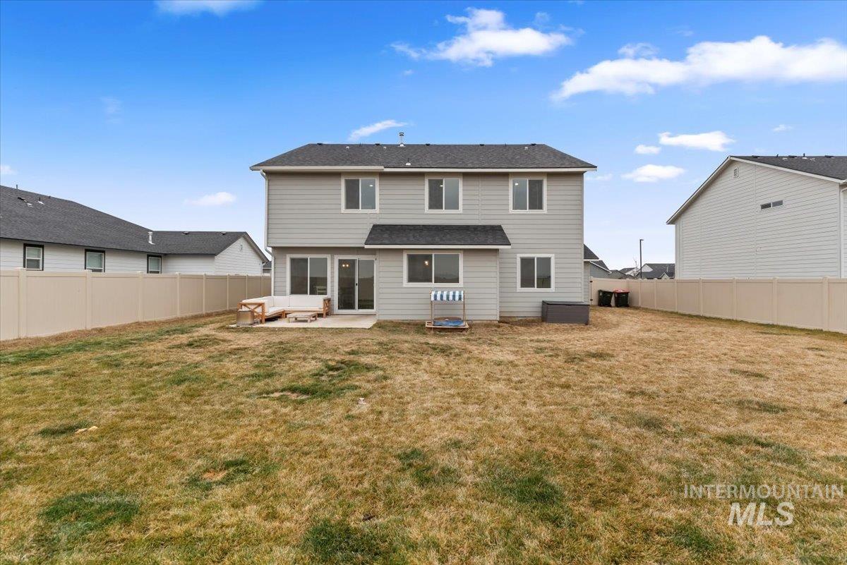 4086 North Kithnos Avenue Meridian, ID 83646 - Photo 28 of 29 Rear view of house featuring a patio and a fenced backyard