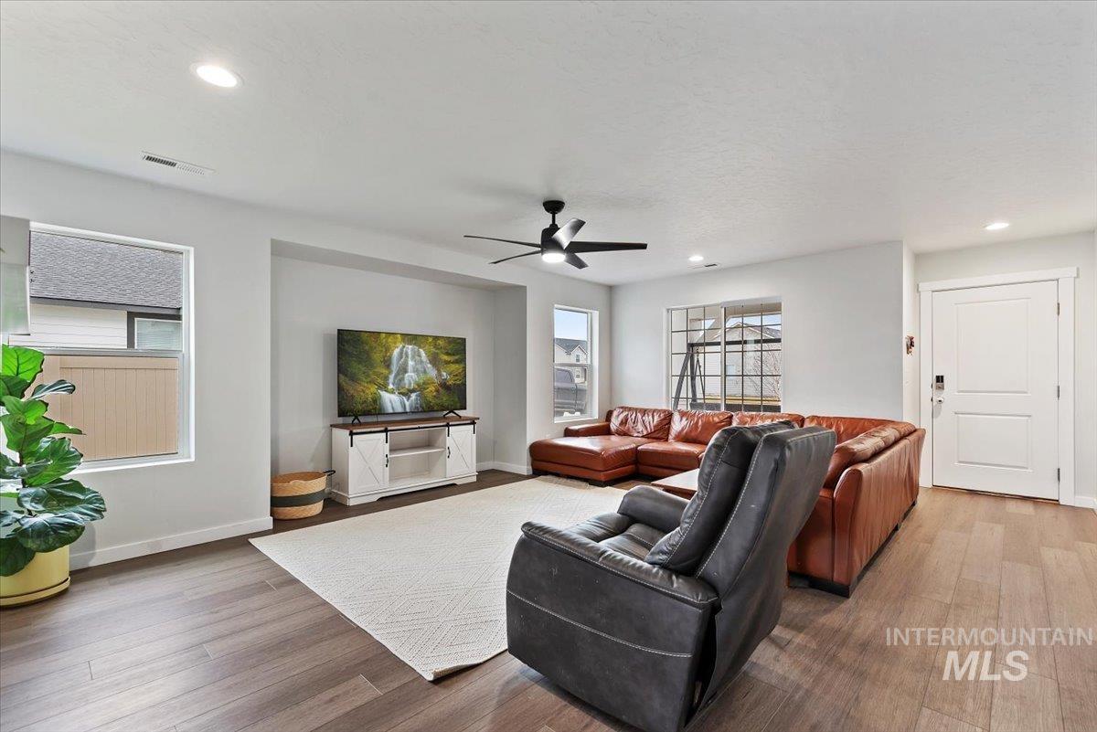 4086 North Kithnos Avenue Meridian, ID 83646 - Photo 4 of 29 Living area with wood finished floors, a ceiling fan, and recessed lighting