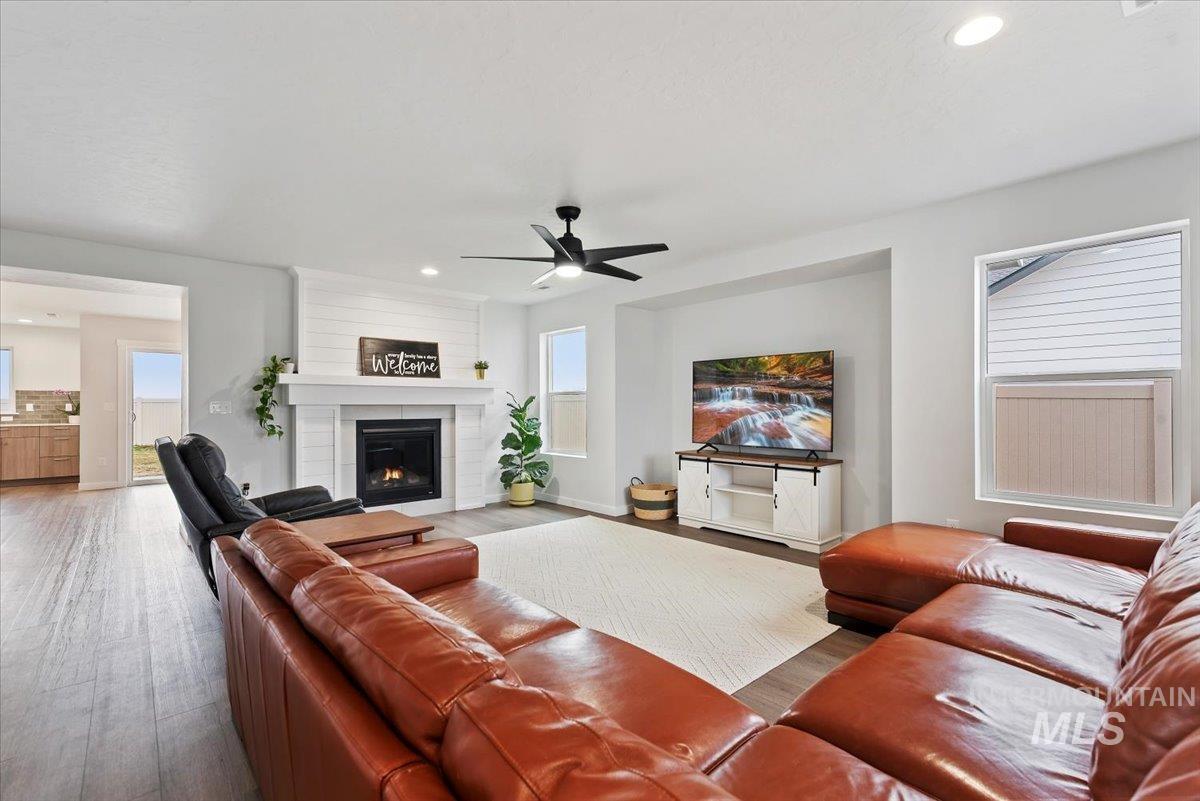 4086 North Kithnos Avenue Meridian, ID 83646 - Photo 5 of 29 Living room with wood finished floors, recessed lighting, a ceiling fan, and a large fireplace