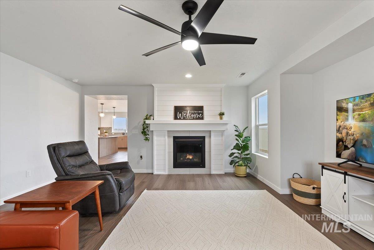 4086 North Kithnos Avenue Meridian, ID 83646 - Photo 6 of 29 Living area with dark wood-style flooring, a fireplace, ceiling fan, and recessed lighting