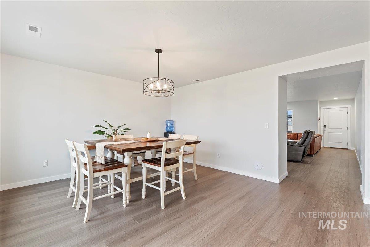 4086 North Kithnos Avenue Meridian, ID 83646 - Photo 7 of 29 Dining area featuring light wood-style floors and a chandelier