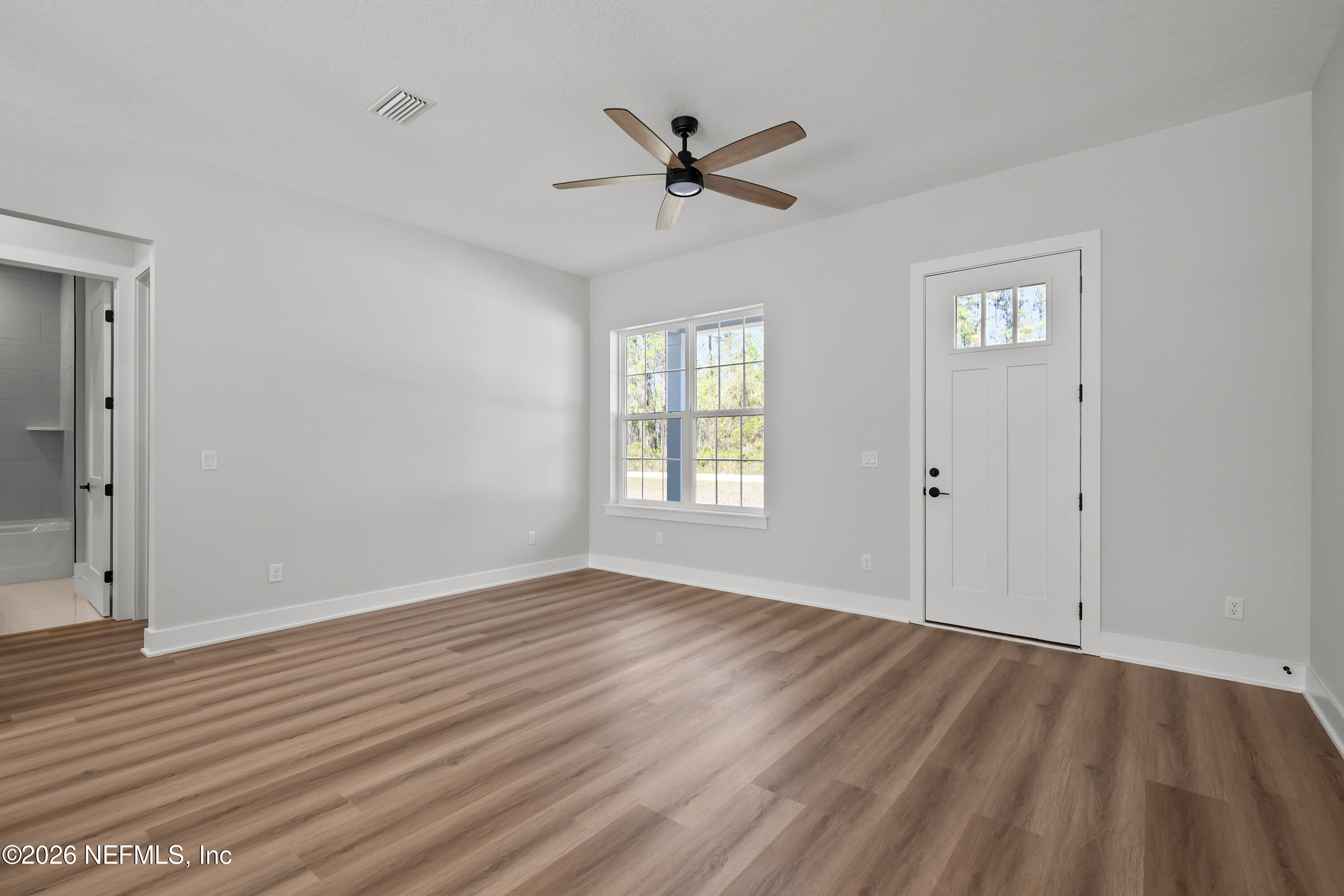 543 Palmetto Bluff Road Palatka, FL 32177 - Photo 11 of 23 wooden floor in an empty room with a window