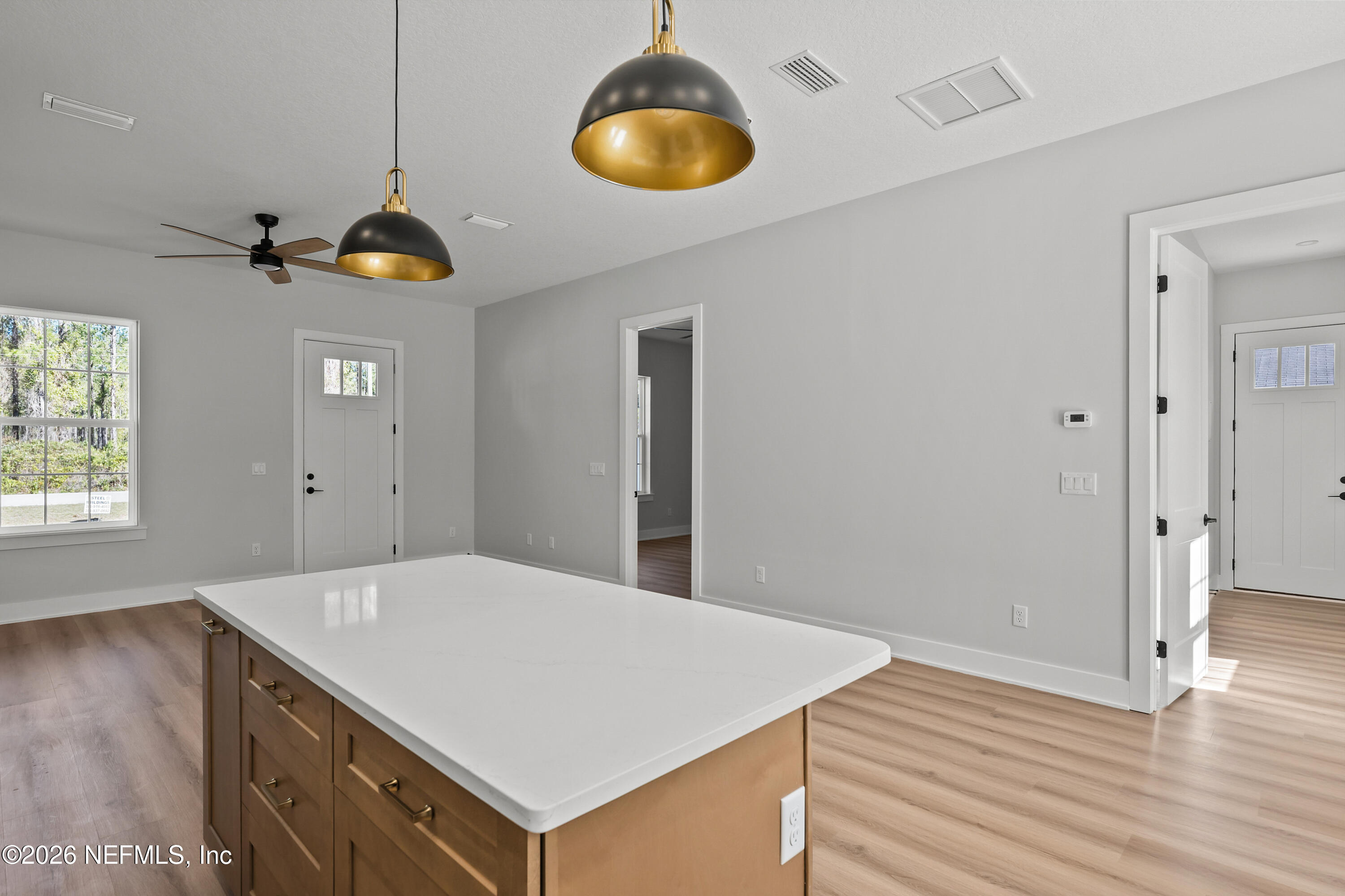 543 Palmetto Bluff Road Palatka, FL 32177 - Photo 12 of 23 a kitchen with a wooden floor and chandelier