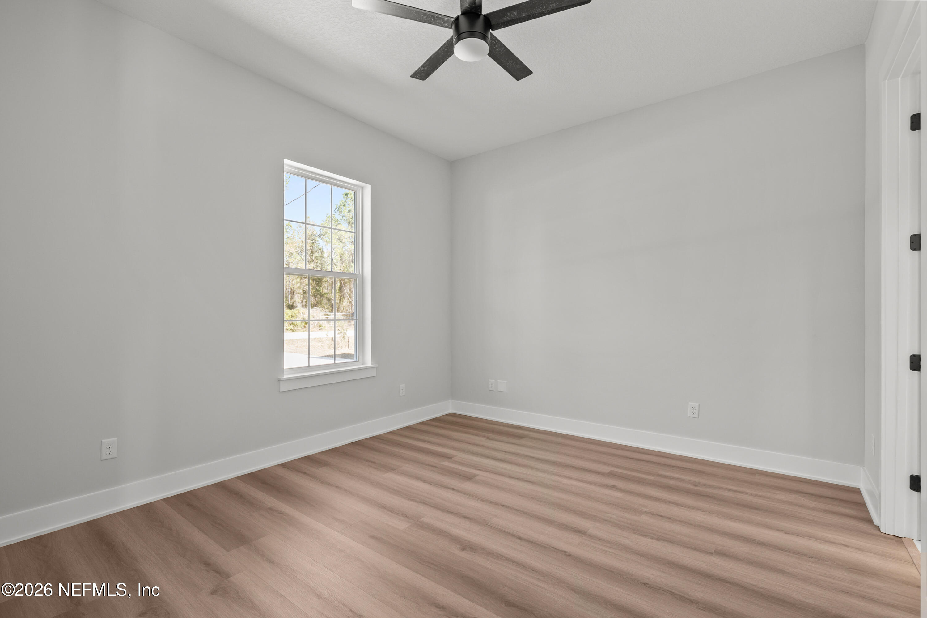 543 Palmetto Bluff Road Palatka, FL 32177 - Photo 13 of 23 wooden floor in an empty room with a window