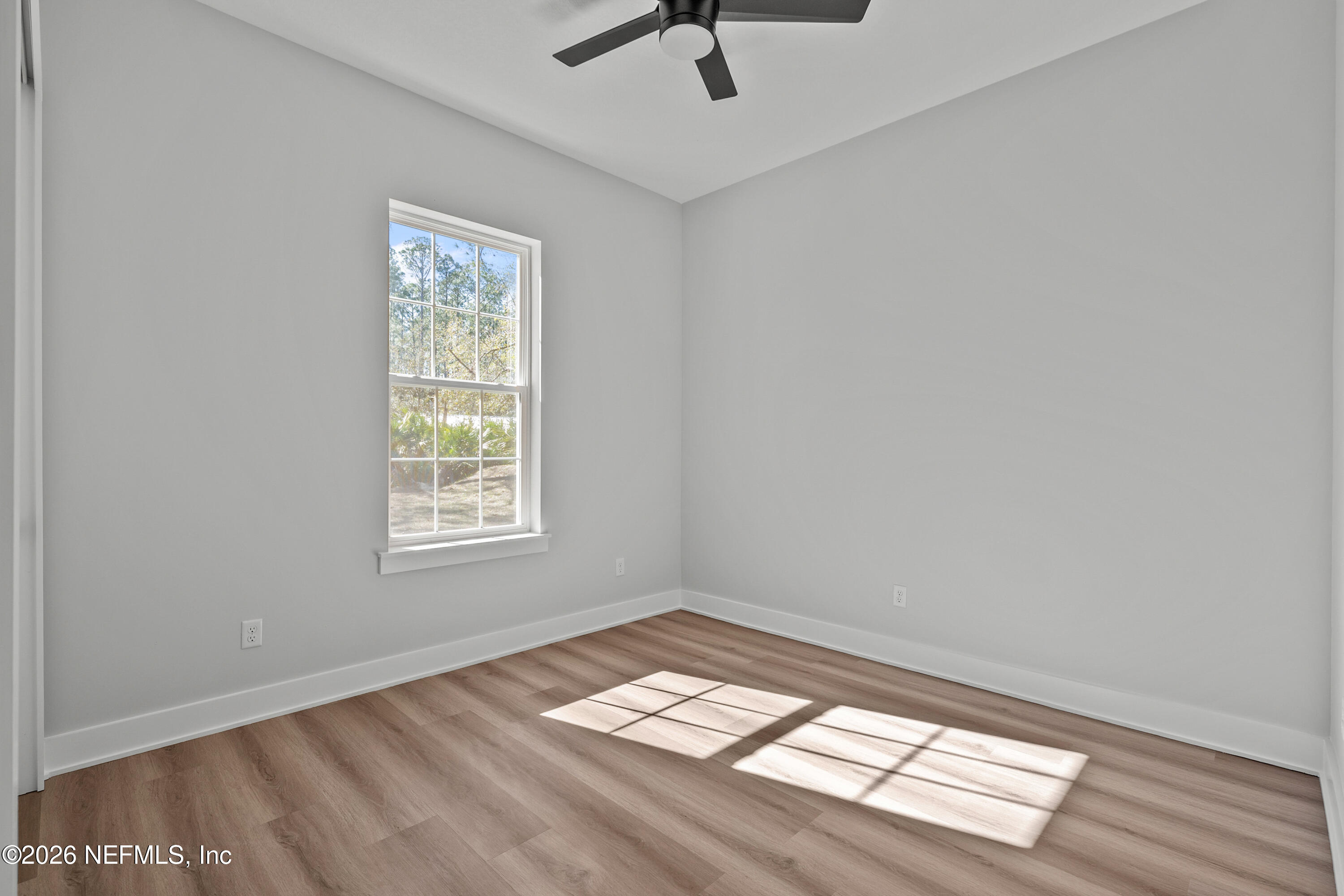 543 Palmetto Bluff Road Palatka, FL 32177 - Photo 16 of 23 a view of empty room with wooden floor and fan