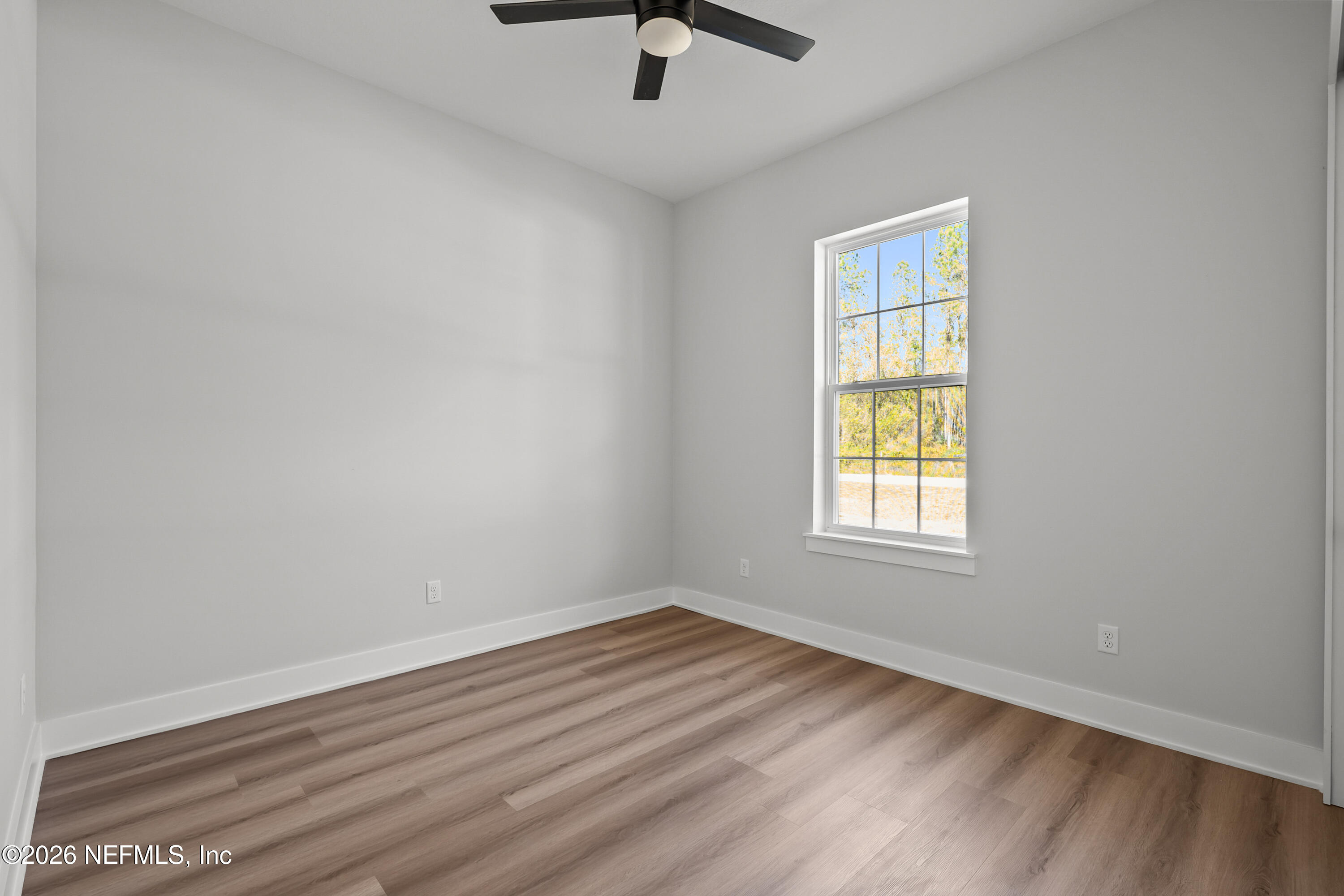 543 Palmetto Bluff Road Palatka, FL 32177 - Photo 17 of 23 an empty room with a window and a ceiling fan