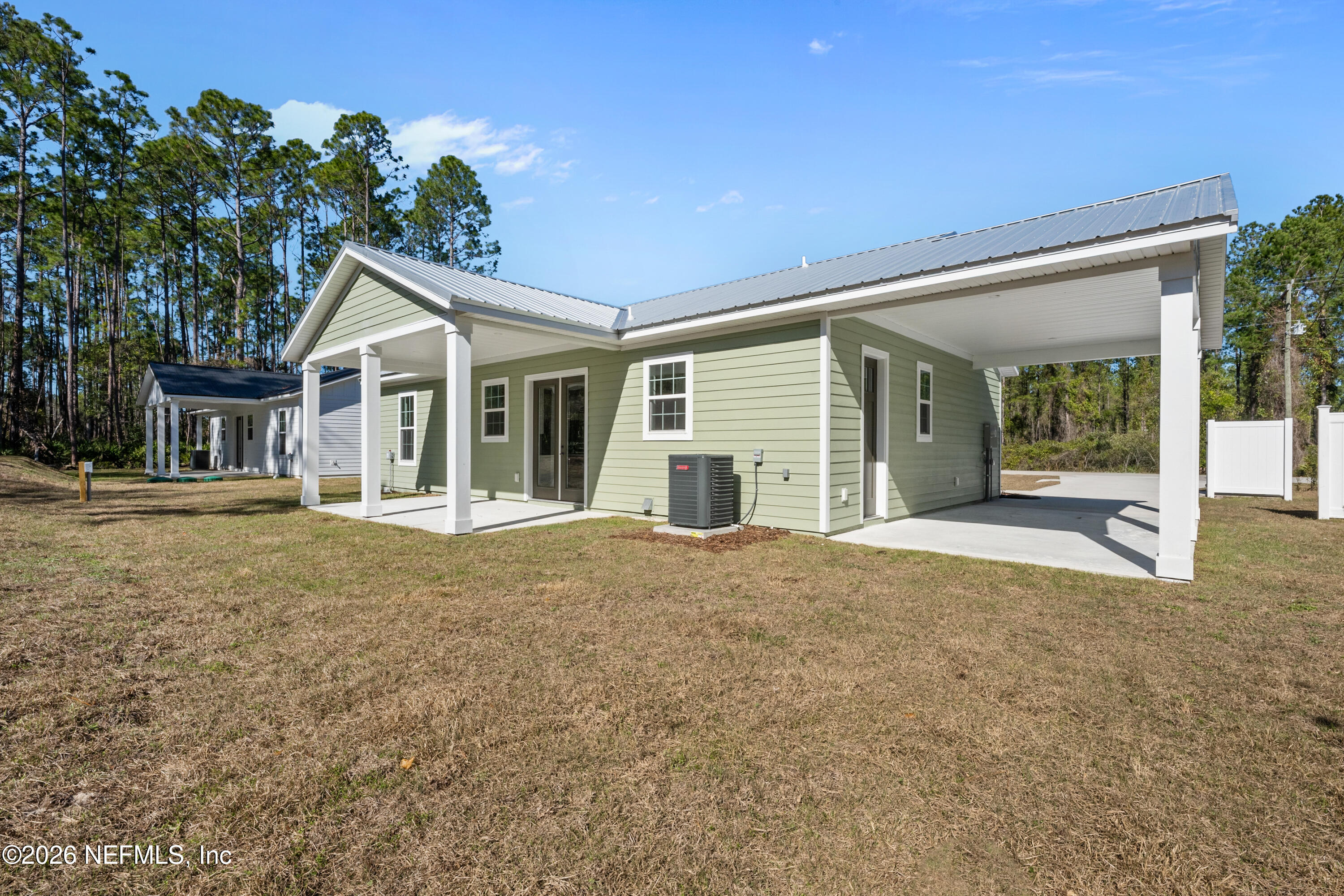 543 Palmetto Bluff Road Palatka, FL 32177 - Photo 22 of 23 a view of house with backyard and glass windows
