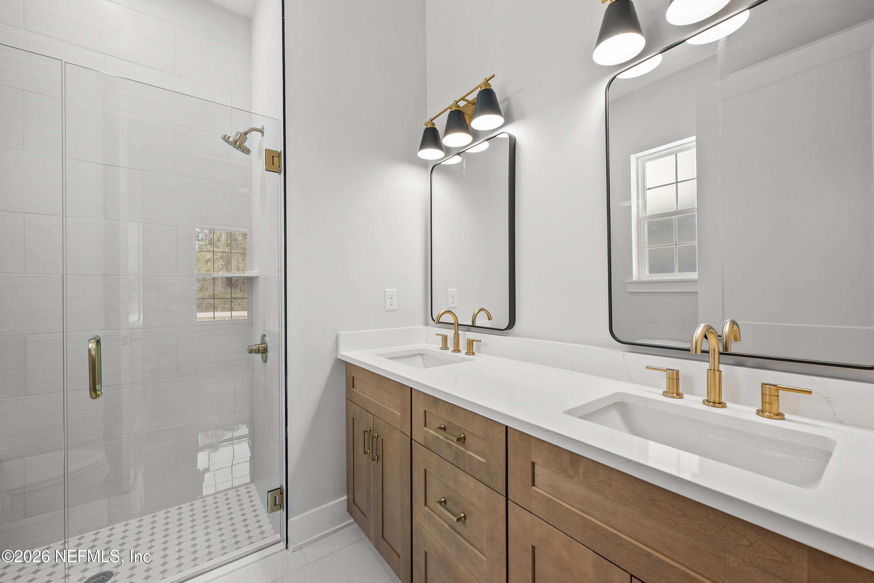 543 Palmetto Bluff Road Palatka, FL 32177 - Photo 3 of 23 a bathroom with a double vanity sink a toilet and shower