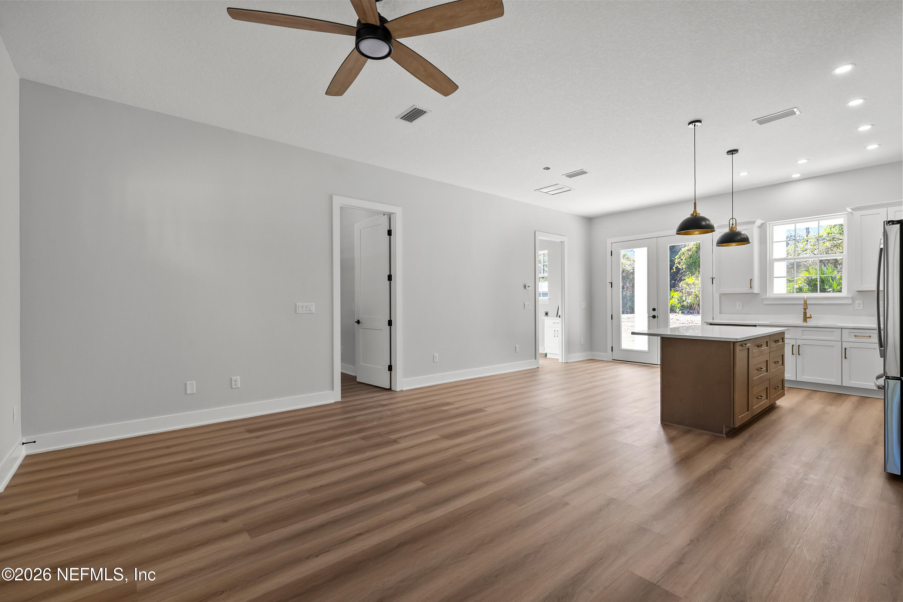 543 Palmetto Bluff Road Palatka, FL 32177 - Photo 10 of 23 a view of kitchen and empty room with wooden floor