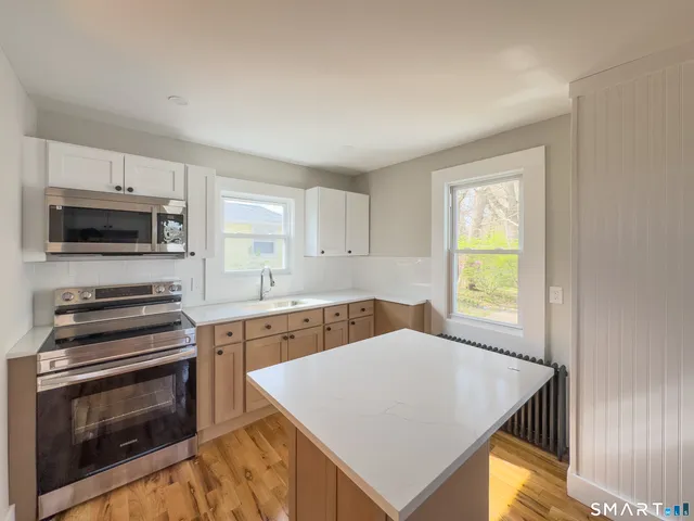 a kitchen with a stove a sink and a microwave