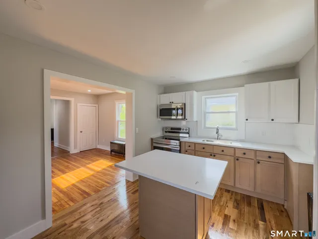 a kitchen with a sink stove and cabinets