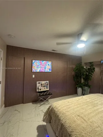 a bedroom with a bed and a television