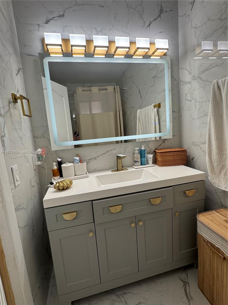 7684 Northwest 179th Street Hialeah, FL 33015 - Photo 8 of 13 a bathroom with a sink and a mirror