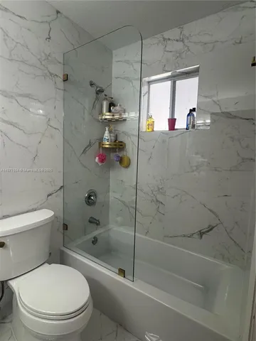 a bathroom with a shower and a toilet
