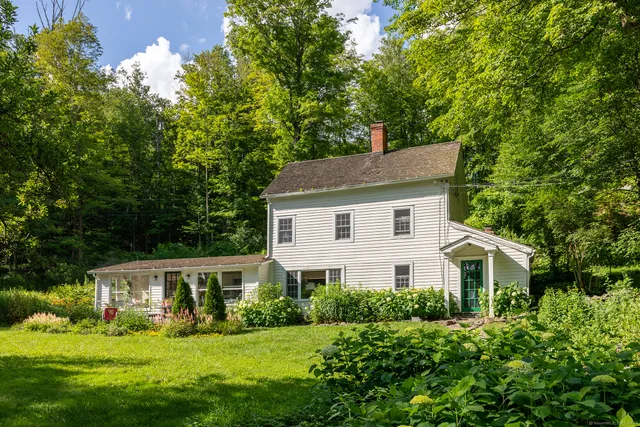 a aerial view of white house with a yard