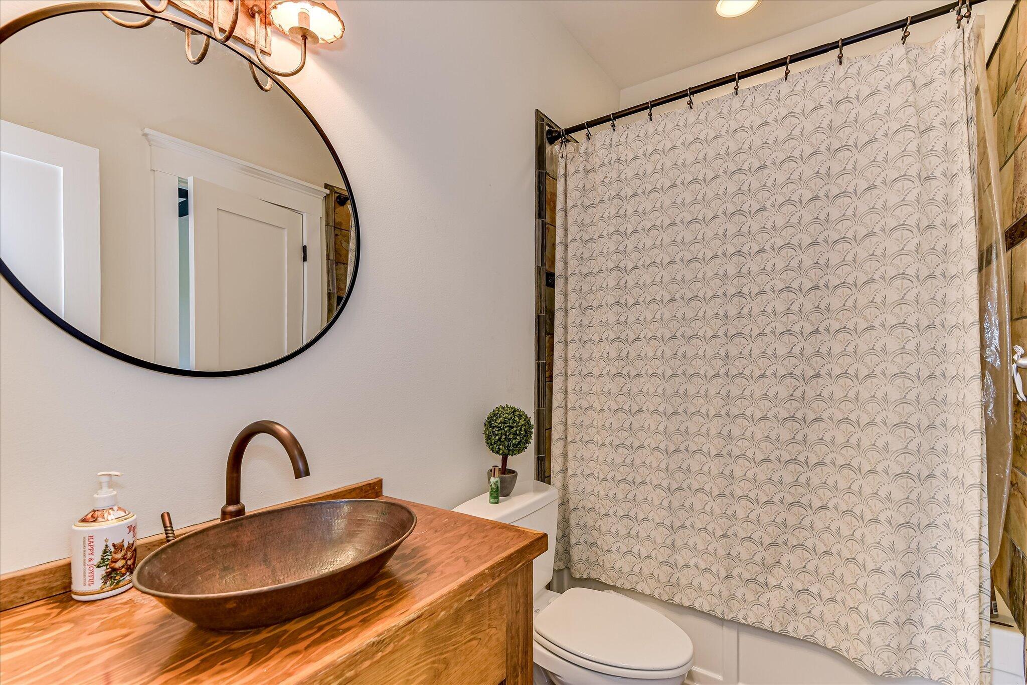 1063 Colbert Bridge Road Aiken, SC 29803 - Photo 16 of 68 a bathroom with a granite countertop toilet sink and mirror
