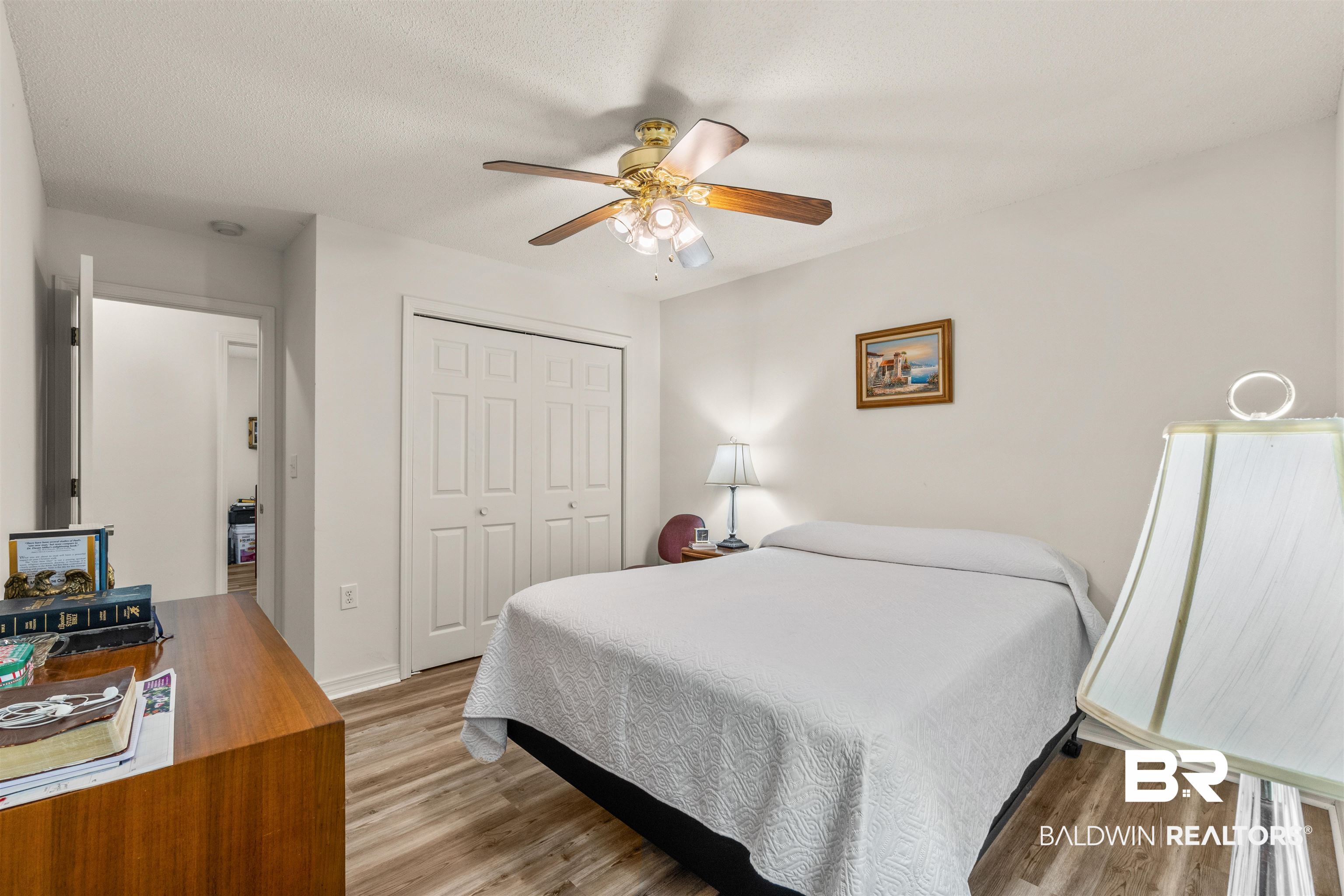35893 Pine Road South Stapleton, AL 36578 - Photo 19 of 31 Room featuring wood-finish flooring, a ceiling fan with integrated lighting, and a double bi-fold closet