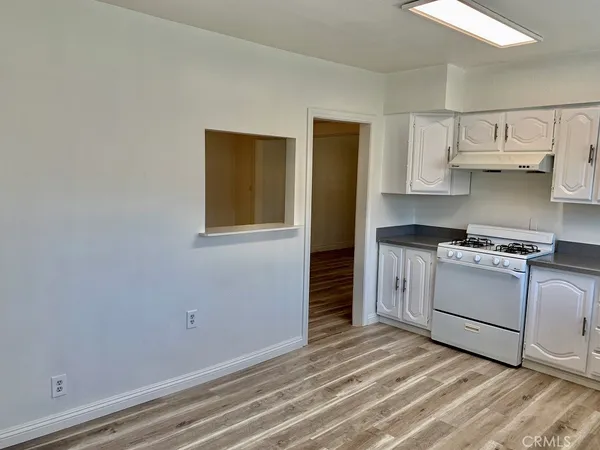 a kitchen with white cabinets and white appliances