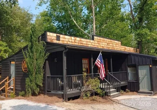 a view of house with a wooden deck