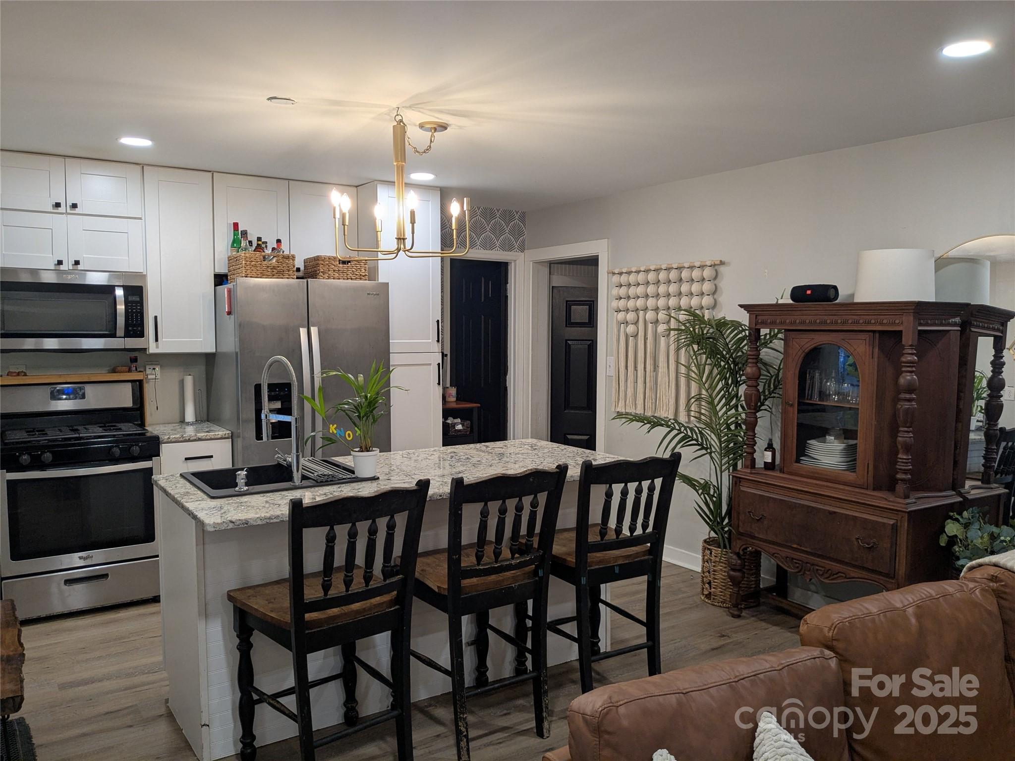 43 Polly Spout Road Marion, NC 28752 - Photo 27 of 34 a kitchen with stainless steel appliances a dining table chairs stove and refrigerator