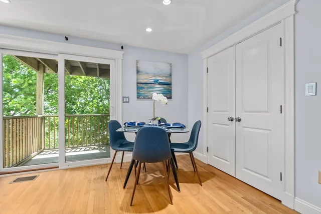 a dining room with furniture and wooden floor