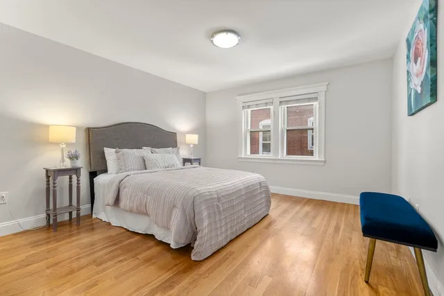 a bedroom with a bed and a chair