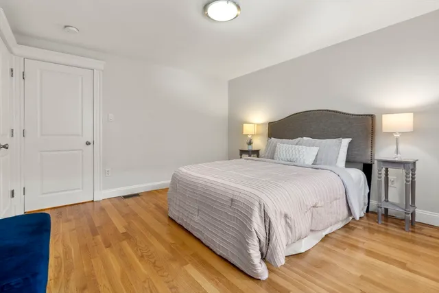 a bedroom with a bed and a night stand