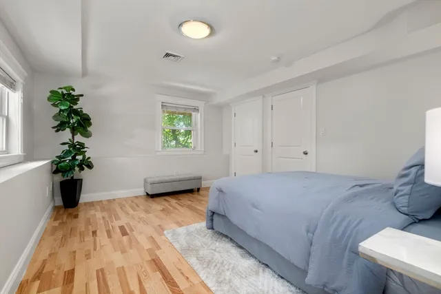 a bedroom with a bed and a potted plant