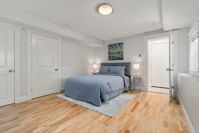 a bedroom with a bed and a painting on the wall