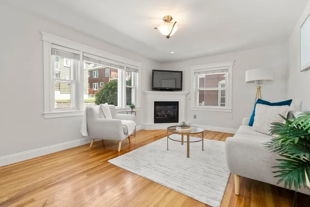 a living room with furniture fireplace and window