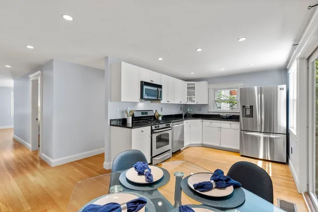 a kitchen with stainless steel appliances granite countertop a sink and a refrigerator