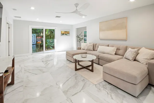 a kitchen with stainless steel appliances granite countertop a table and chairs in it