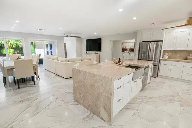 a living room with furniture and large windows