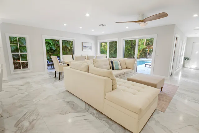 a dining room with furniture and a view of kitchen