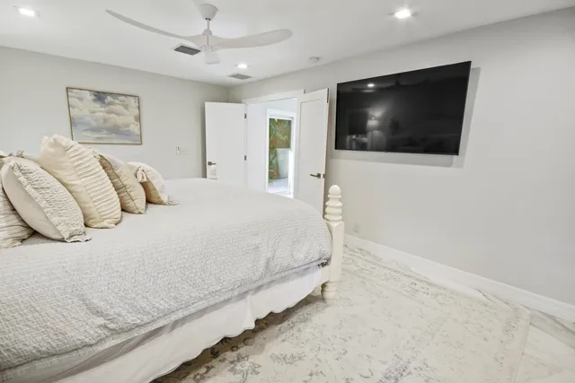 a spacious bedroom with a bed and a chair