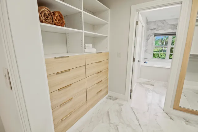 a bedroom with a bed and painting on the wall