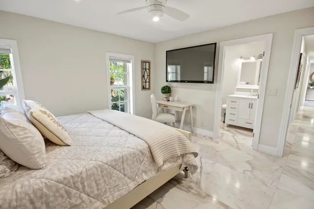 a kitchen with white cabinets and white appliances