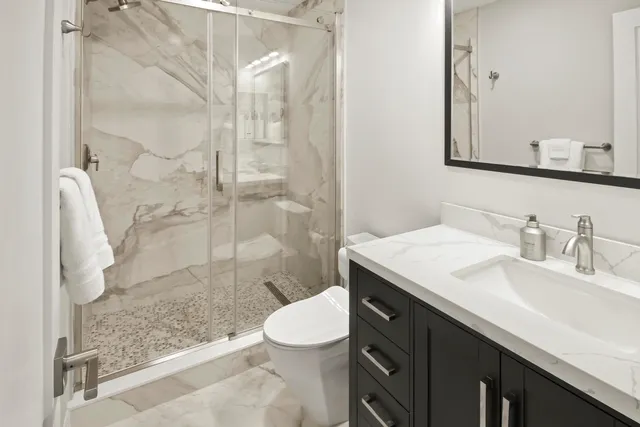 a patio with table and chairs and potted plants