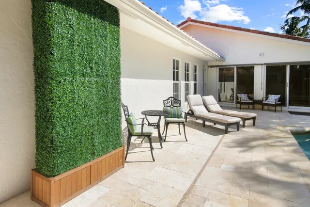 a view of backyard with plants and outdoor seating