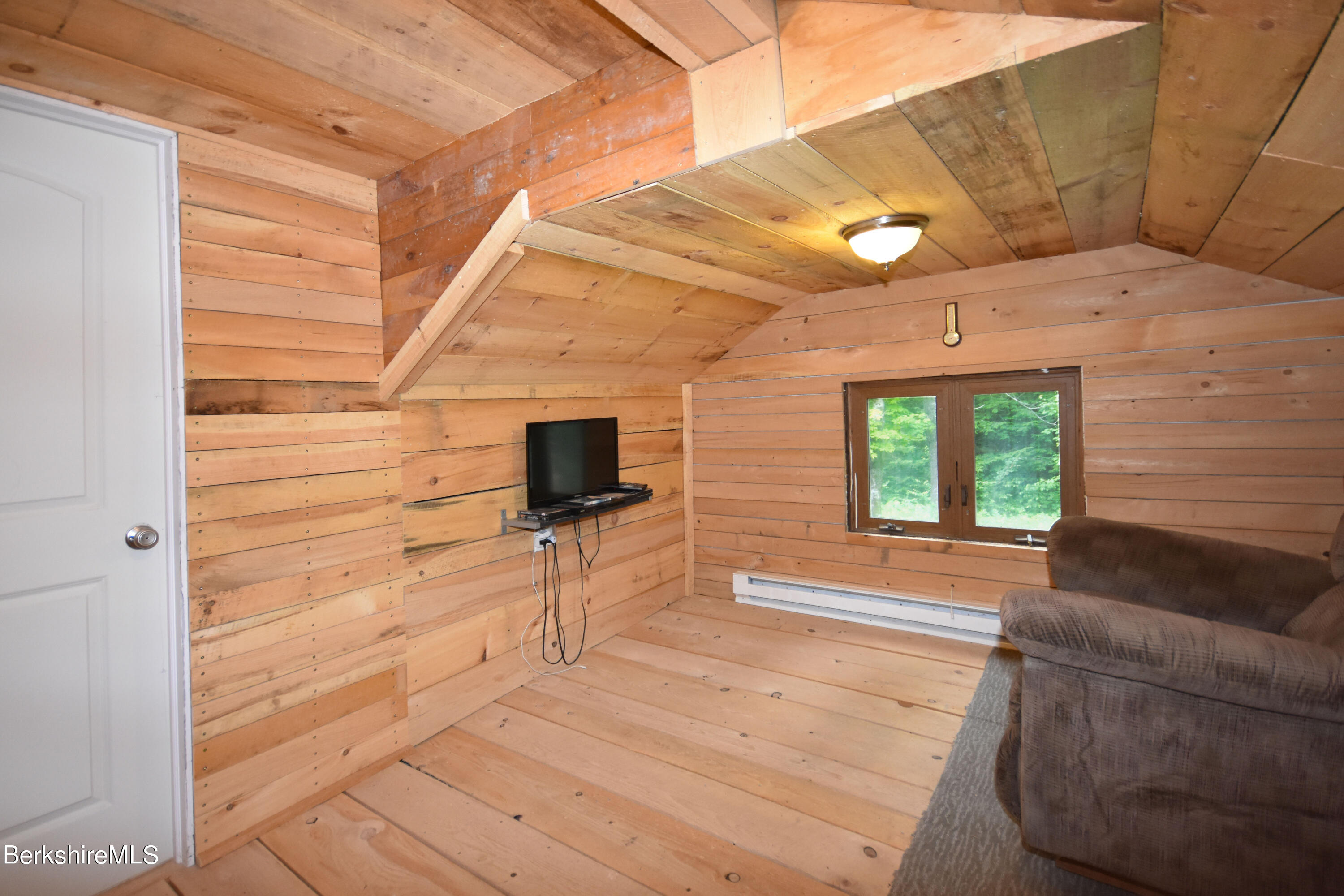 523 Center Road Savoy, MA 01256 - Photo 18 of 31 a view of a livingroom with furniture and a flat screen tv