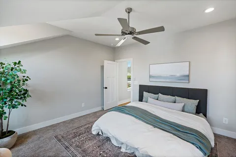 a bedroom with a bed and a potted plant