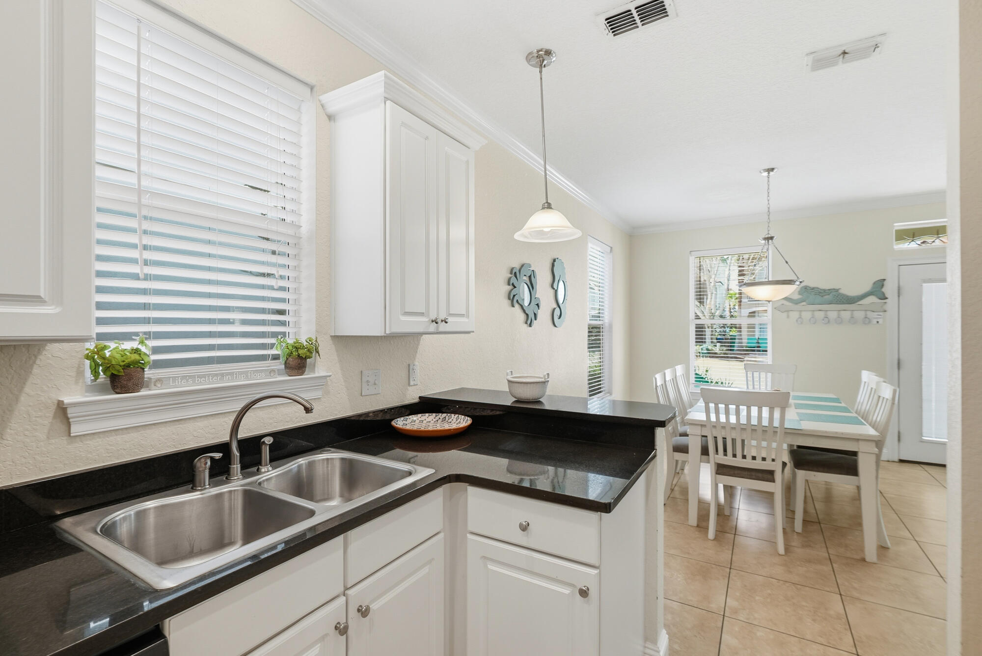 231 Kono Way Destin, FL 32541 - Photo 12 of 41 a kitchen with a sink cabinets and table
