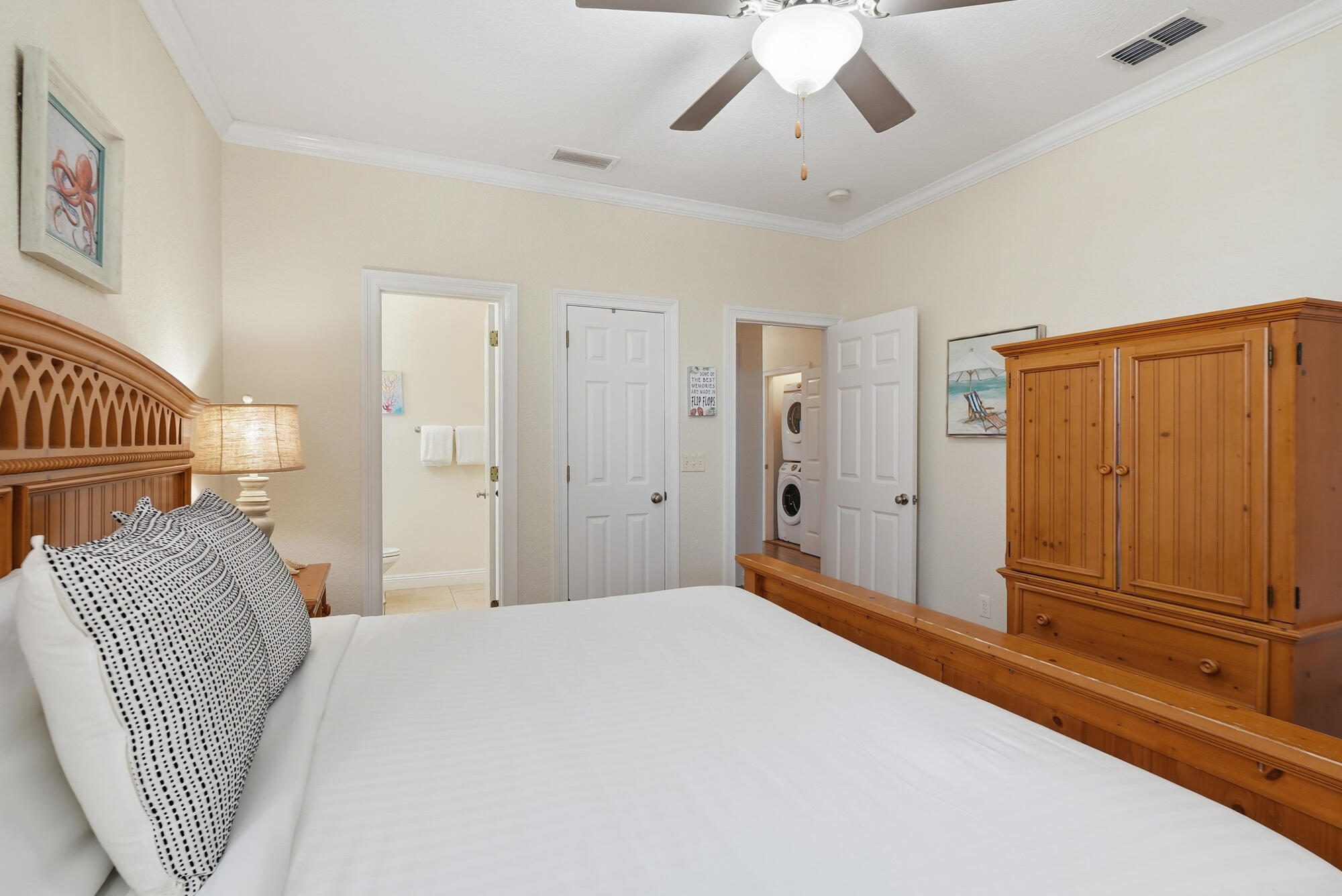 231 Kono Way Destin, FL 32541 - Photo 27 of 41 a bedroom with a large bed and chandelier